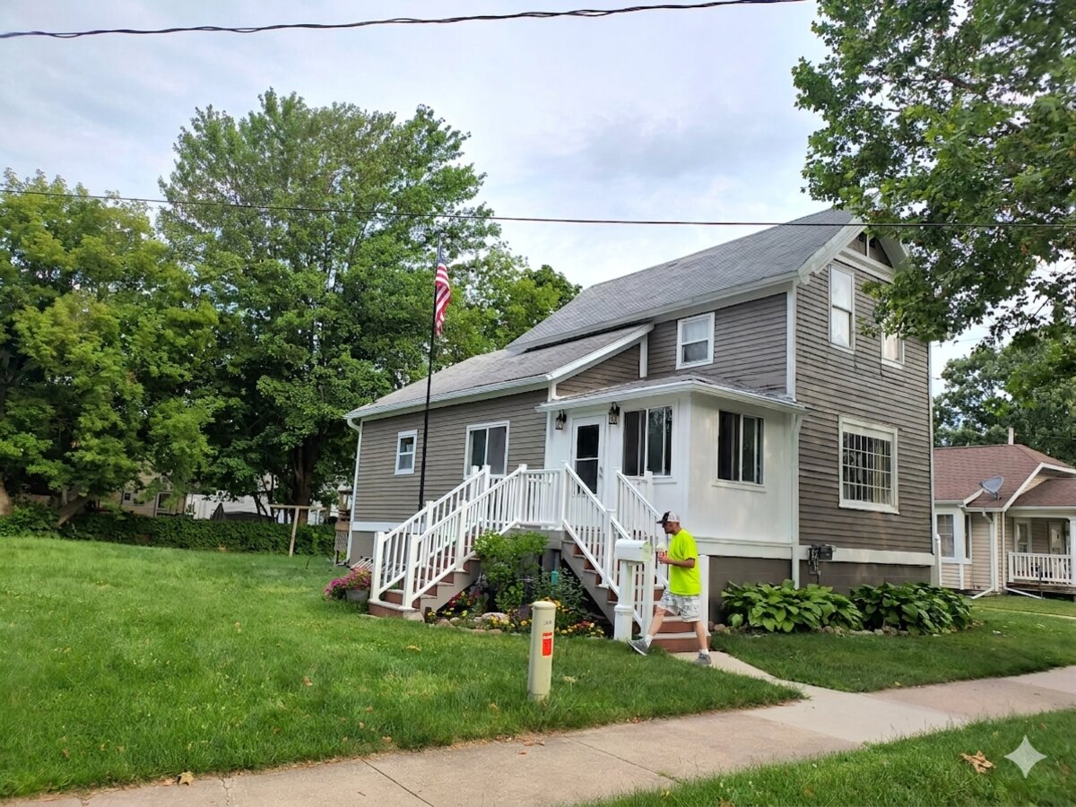 Rick Humpert of Humpert Painting LLC standing on the steps of a freshly painted home in Bay City, MI